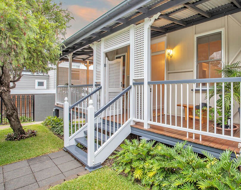 4 steps leading up to the front patio of a charming home in brisbane