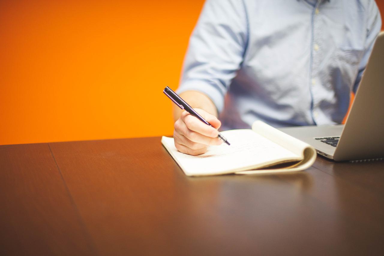 A person writing in a notebook