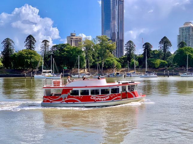Cityhopper ferry cruising next to Brisbane CBD