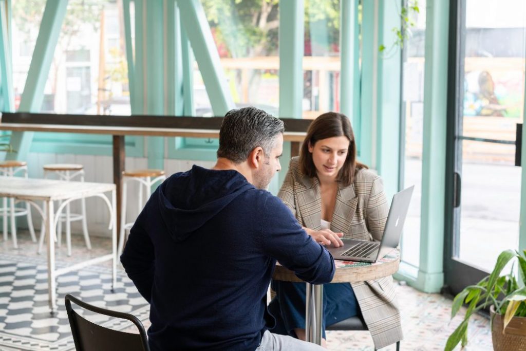 Investor and manager talking in cafe